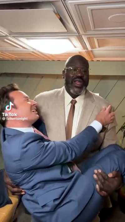 Shaq holding Jimmy Fallon