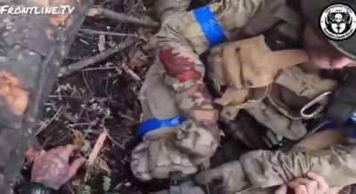An American volunteer from the "Kenobi Death Korps" unit (1st Battalion of the International Legion) resques a wounded Canadian volunteer in Ukraine