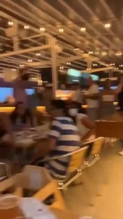 Baby raises his arms and somebody notices, then the whole restaurant joins in.
