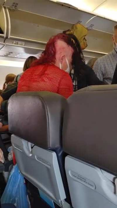 The person in red was in the bathroom during the entire landing process after being asked many times to come out and take a seat by flight staff. After which this happened.