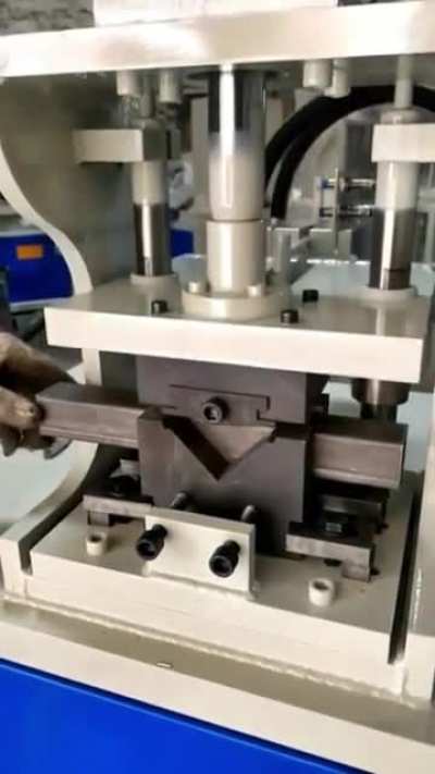 Machine cuts tubular steel so it can be bent into a right angle