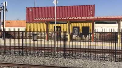 Video - Cargo Train Passing by Train Station