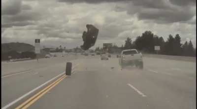 Tire comes off lifted truck causing Kia to go airborne